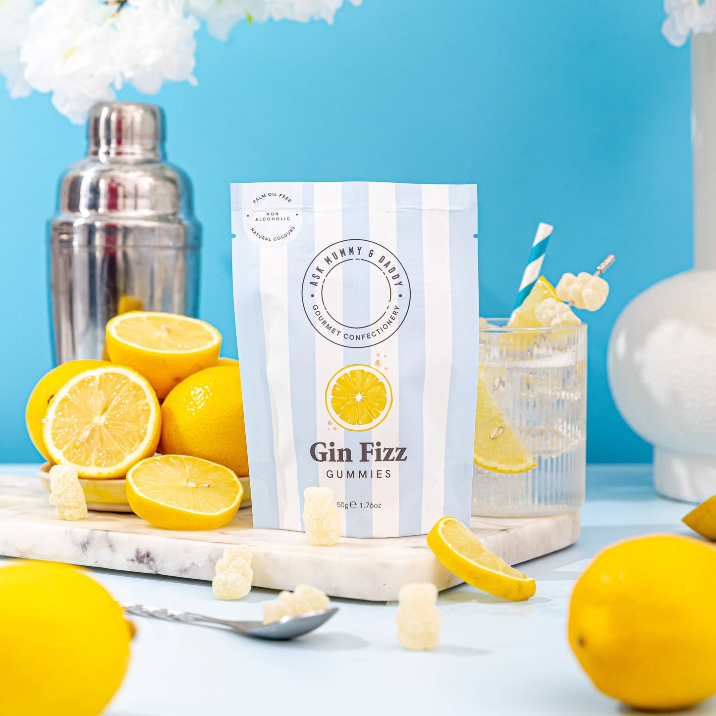 Gin Fizz gummies packaging with lemons and a cocktail on a blue background