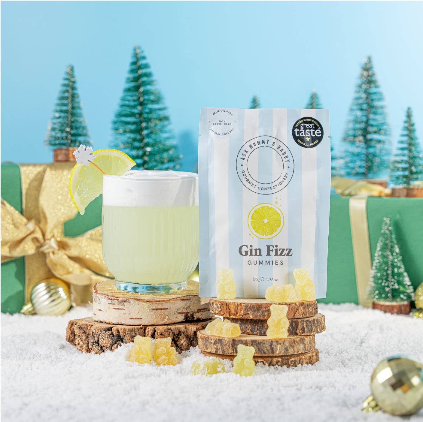 Gin Fizz gummies with a glass of gin and tonic in a festive setting.