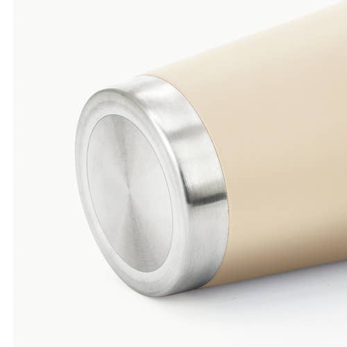 Close-up of a cylindrical product showing a brushed silver metal end cap and a warm beige body on a clean white background.