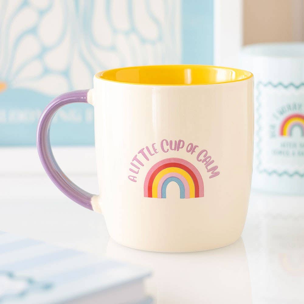 colourful rainbow mug with pink handle and yellow interior
