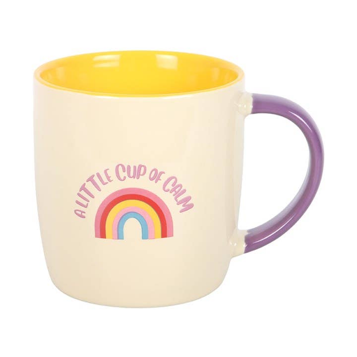 Mug with rainbow design and text 'A Little Cup of Calm' on a white background