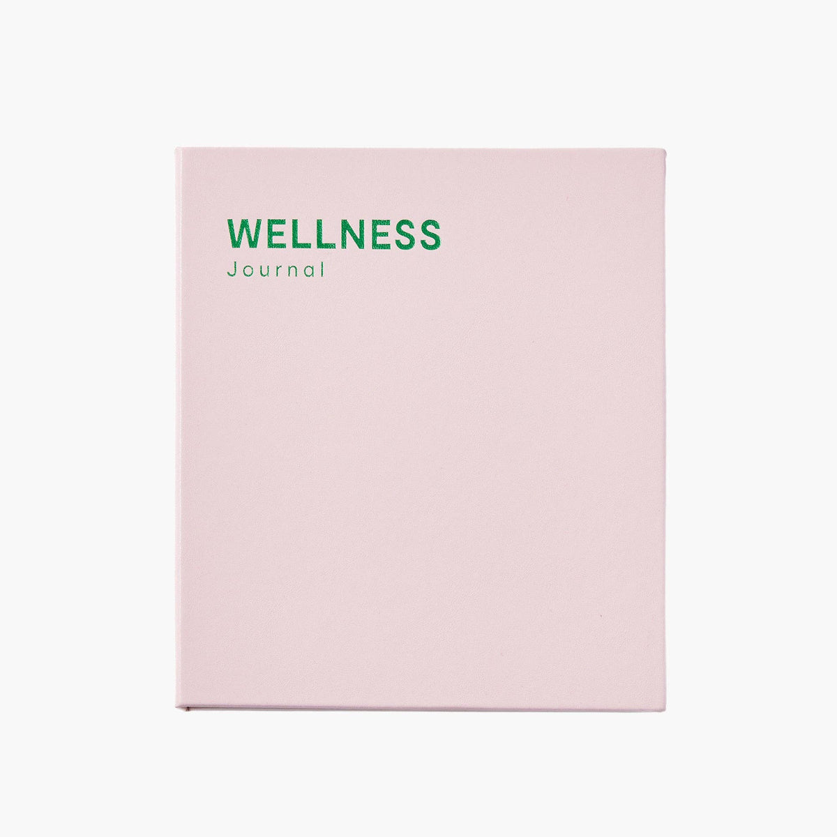 A light pink journal with the words 'WELLNESS Journal' printed in green at the top, shown against a plain white background.