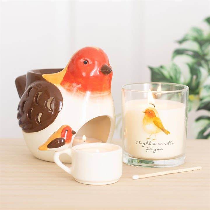 memorial candle with robin illustration and cranberry clove scent