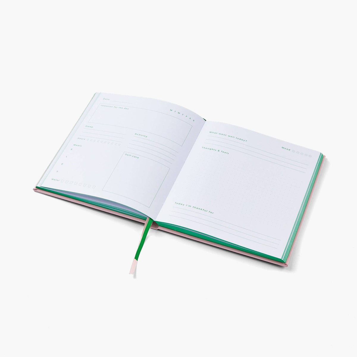 An open daily planner or journal with blank lined pages, a green ribbon bookmark, and green-edged covers, photographed on a clean white background.
